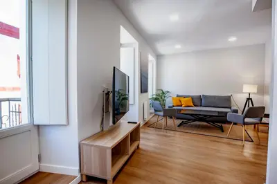 a living room with a tv and a couch at SNÖ Camino do Eume Apartamentos in Puentedeume