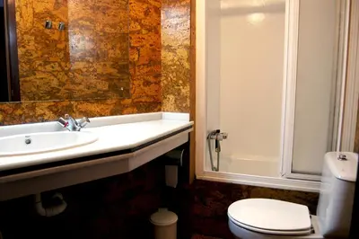 a bathroom with a sink and a toilet at Hostal Charo II in Santiago de Compostela