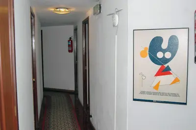 a hallway with a painting on the wall and a hallway sidx sidx at Hostal Charo II in Santiago de Compostela
