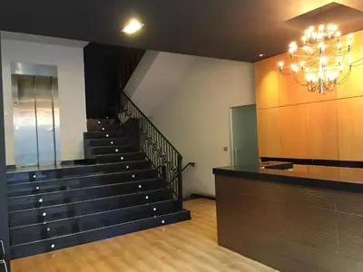 a lobby with stairs and a chandelier in a building at Hotel Restaurante Derby in Carballino