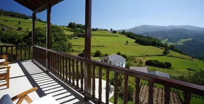 a balcony of a house with a view of the mountains at Hotel Rural Palacio de Prelo in Boal