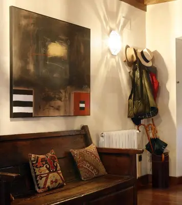 a living room with a couch and a painting at Hotel Rural Palacio de Prelo in Boal