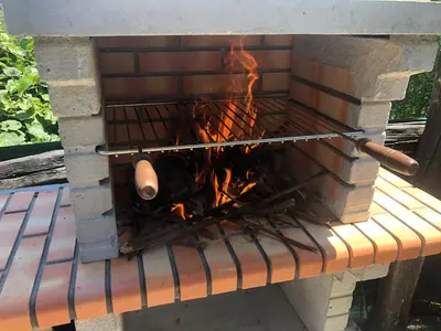 a brick oven with a fire in it at O Prado do Forno in O Barco de Valdeorras
