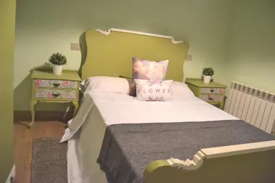 a bed with a pillow with the word love on it at O Prado do Forno in O Barco de Valdeorras