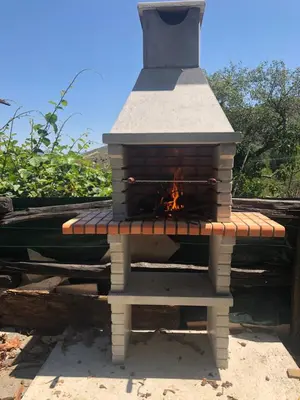 a brick oven with a fire inside of it at O Prado do Forno in O Barco de Valdeorras
