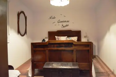 a bedroom with a bed with a sign on the wall at O Prado do Forno in O Barco de Valdeorras