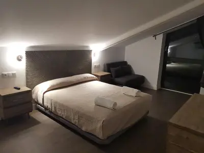 a bedroom with a bed and a couch and a chair at VILLA MAREL in Trefacio