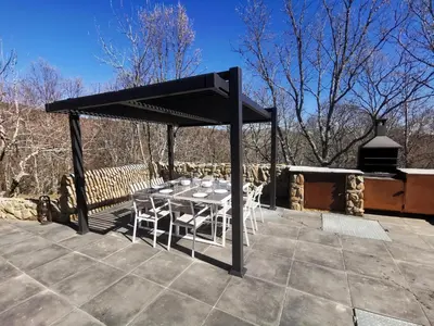 a table and chairs under a canopy on a patio at VILLA MAREL in Trefacio