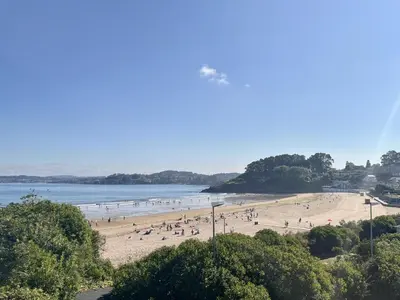 a group of people on a beach near the water at AFTER Hotel in Bastiagueiro
