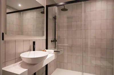 a bathroom with a sink and a shower at AFTER Hotel in Bastiagueiro