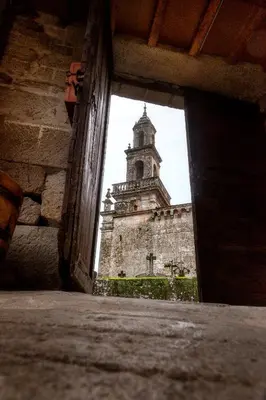 a building with a clock tower in the background at CASA RECTORAL DE SAN EUSEBIO in Ourense