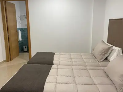 a large bed in a room with at Os Arcos - Apartamentos Turísticos in Portomarin
