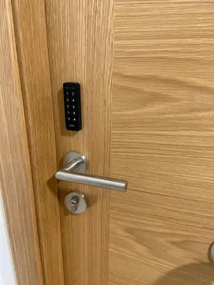 a close up of a door with a remote control at Os Arcos - Apartamentos Turísticos in Portomarin