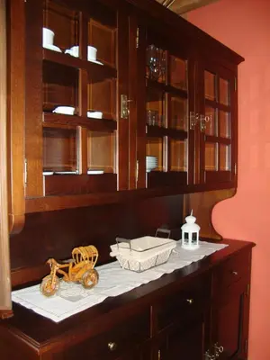 a kitchen counter with wooden cabinets and a toy motorcycle on it at Apartamentos Rurales Posada de las Hoces in Bustiello de Paredes