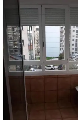 a window in a bathroom with a view of a city at Enseñanza in Ourense
