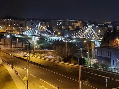 a bridge over a city at night with lights at Piso termal in Ourense