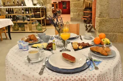 a table topped with plates of food and drinks at Gandarela Turismo Rural in Ourense