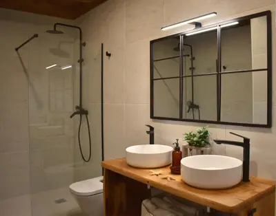 a bathroom with two sinks and a shower at Gandarela Turismo Rural in Ourense