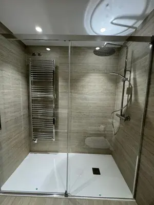 a shower with a glass door in a bathroom at O recuncho in Monforte de Lemos