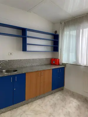 a kitchen with blue cabinets and a sink at O recuncho in Monforte de Lemos