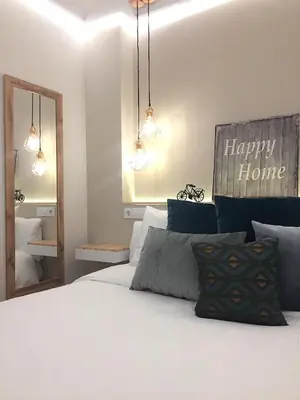 a bedroom with a white bed with a happy home sign on the wall at Nordico in Ourense