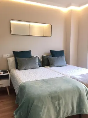 two beds sitting next to each other in a bedroom at Nordico in Ourense