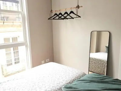 a bedroom with a mirror next to a bed at Nordico in Ourense