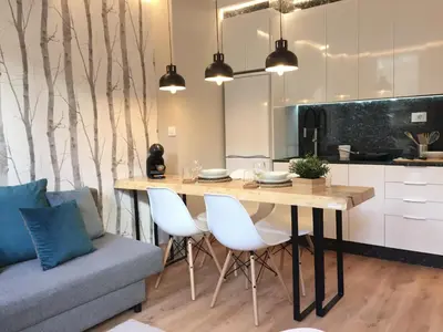 a kitchen and dining room with a table and a couch at Nordico in Ourense