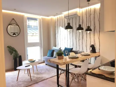 a kitchen and living room with a table and chairs at Nordico in Ourense