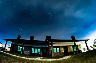 a building with green lights on the side of it at Apartamentos Rurales Camín Real in La Caridad