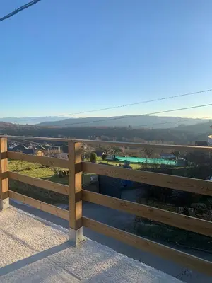 a wooden fence with a view of a field at La casa de la valla azul (San Miguel de Langre) in San Miguel de Langre