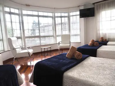a bedroom with two beds and a flat screen tv at PR Una Estrella Dorada in O Pedrouzo