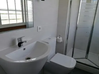 a bathroom with a sink and a toilet and a shower at PR Una Estrella Dorada in O Pedrouzo