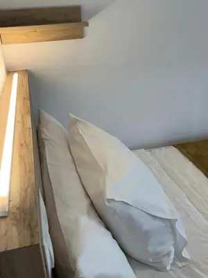 a bed with two pillows on it in a room at PR Una Estrella Dorada in O Pedrouzo