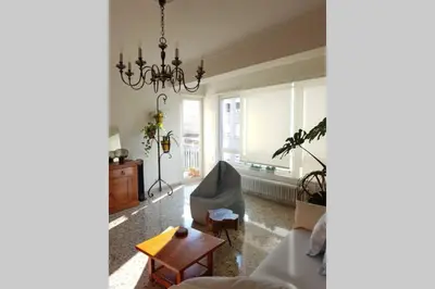 a living room with a couch and a chandelier at Amplio y luminoso piso en el centro de Ourense in Ourense