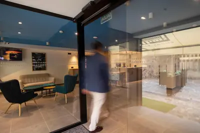 a man walking past a window in a store at Alameda Rooms Santiago in Santiago de Compostela