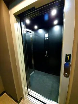 a glass door to a elevator in a building at Solarena Bistrot in Barreiros