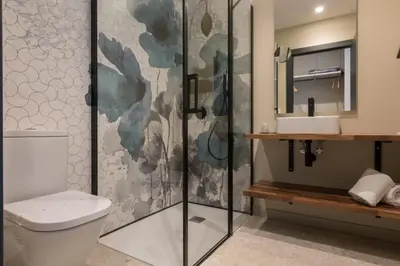 a bathroom with a shower and a toilet and a sink at Solarena Bistrot in Barreiros