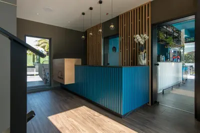 a hallway with a blue counter in a house at Solarena Bistrot in Barreiros
