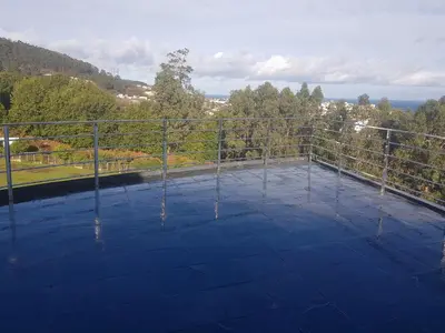 a view from the top of a roof with a fence at Apartamentos Burela in Burela de Cabo