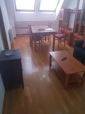 a living room with a table and a couch at Apartamentos Burela in Burela de Cabo