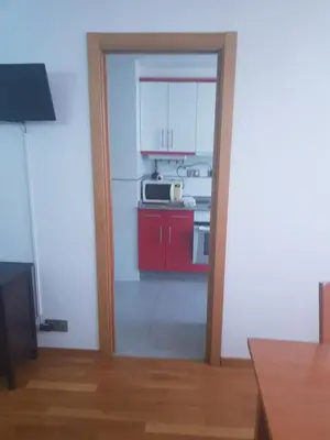 an open door into a kitchen with a microwave at Apartamentos Burela in Burela de Cabo