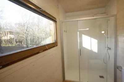 a bathroom with a shower and a window at Cabanas das Chousas in Lugo