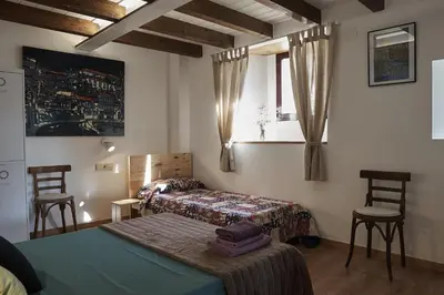 a dining room with a chair and a door at Parga Natura Alojamiento in Parga