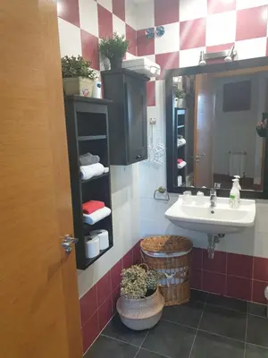 a bathroom with a sink and a mirror at Apartamento Ático Cine Colón in Ribadeo