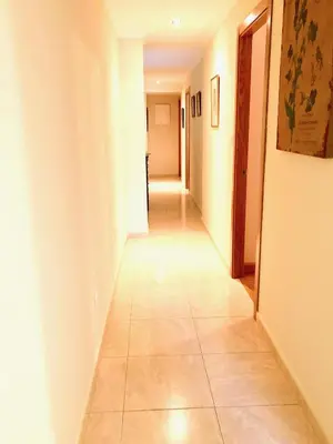 a long hallway with a tile floor in a room at Marina Sol te hará soñar in Vivero
