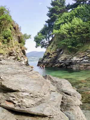 two people swimming in a body of water at Marina Sol te hará soñar in Vivero
