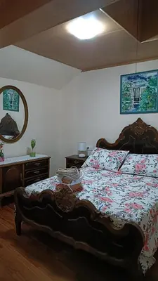 a bedroom with a bed and a mirror and a table at Casa Quintela in Ourense
