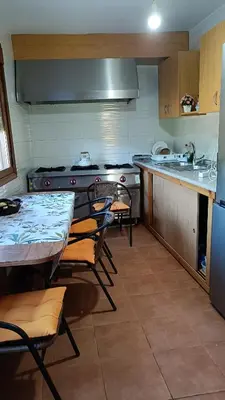 a kitchen with a table and chairs and a stove at Casa Quintela in Ourense
