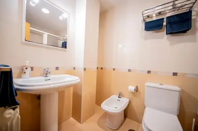 a bathroom with a sink and a toilet and a mirror at Noja rooms 1 in O Pedrouzo